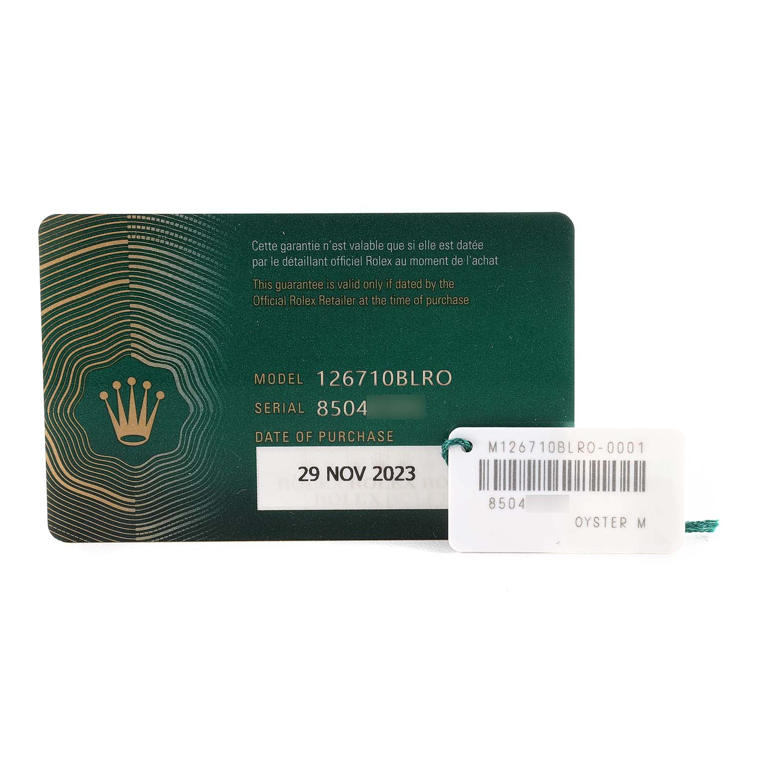 The image shows the warranty card and tag for a Rolex GMT-Master 126710BLRO Men
s Stainless Steel Black Dial 126710BLRO Men
s Stainless Steel Black Dial model 126710BLRO, with purchase date and serial number visible.