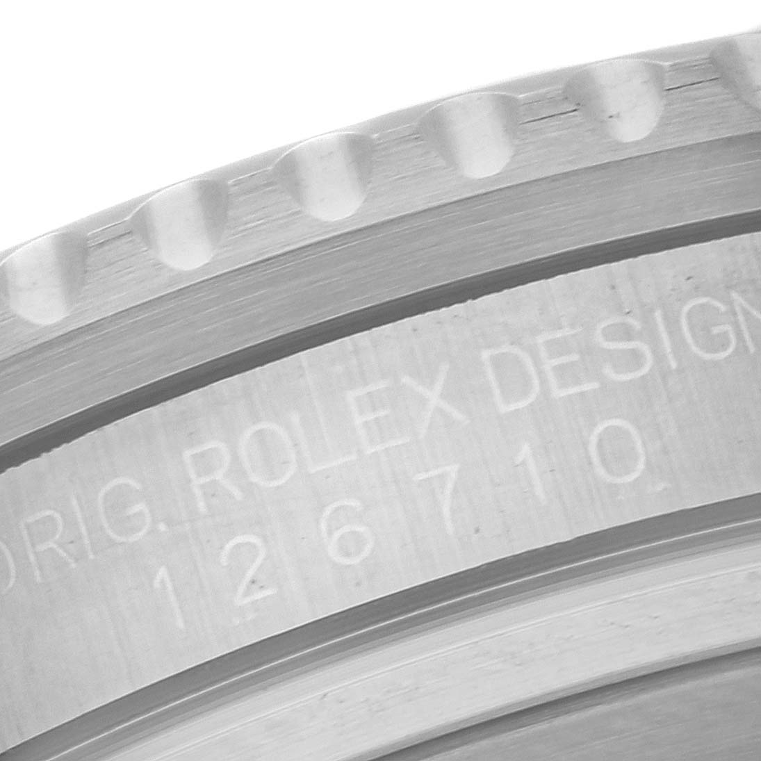 The image shows a close-up of the bezel and case side of a Rolex GMT-Master 126710BLRO Men
s Stainless Steel Black Dial 126710BLRO Men
s Stainless Steel Black Dial, highlighting the engraving "ORIG. ROLEX DESIGN 126710."