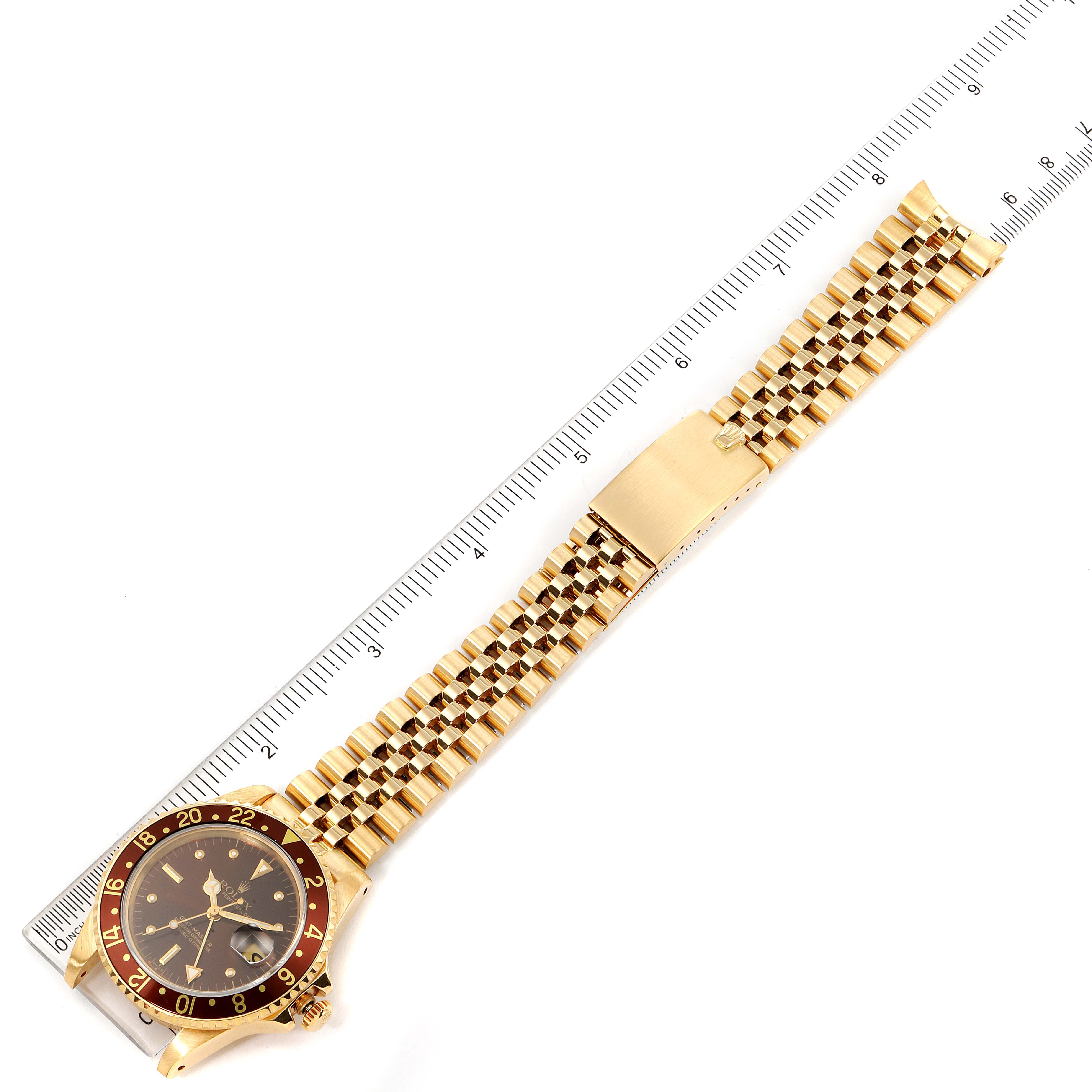 The image shows a Rolex Vintage Collection 16758 Men's Yellow Gold Brown Dial 16758 Men's Yellow Gold Brown Dial watch lying flat next to a ruler, displaying the face, bezel, and bracelet.