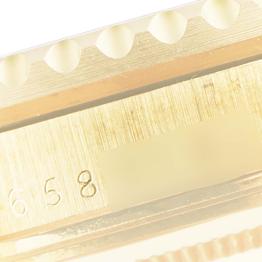 The close-up image shows the side angle of a Vintage Collection Rolex watch bezel and engraved numbers.
