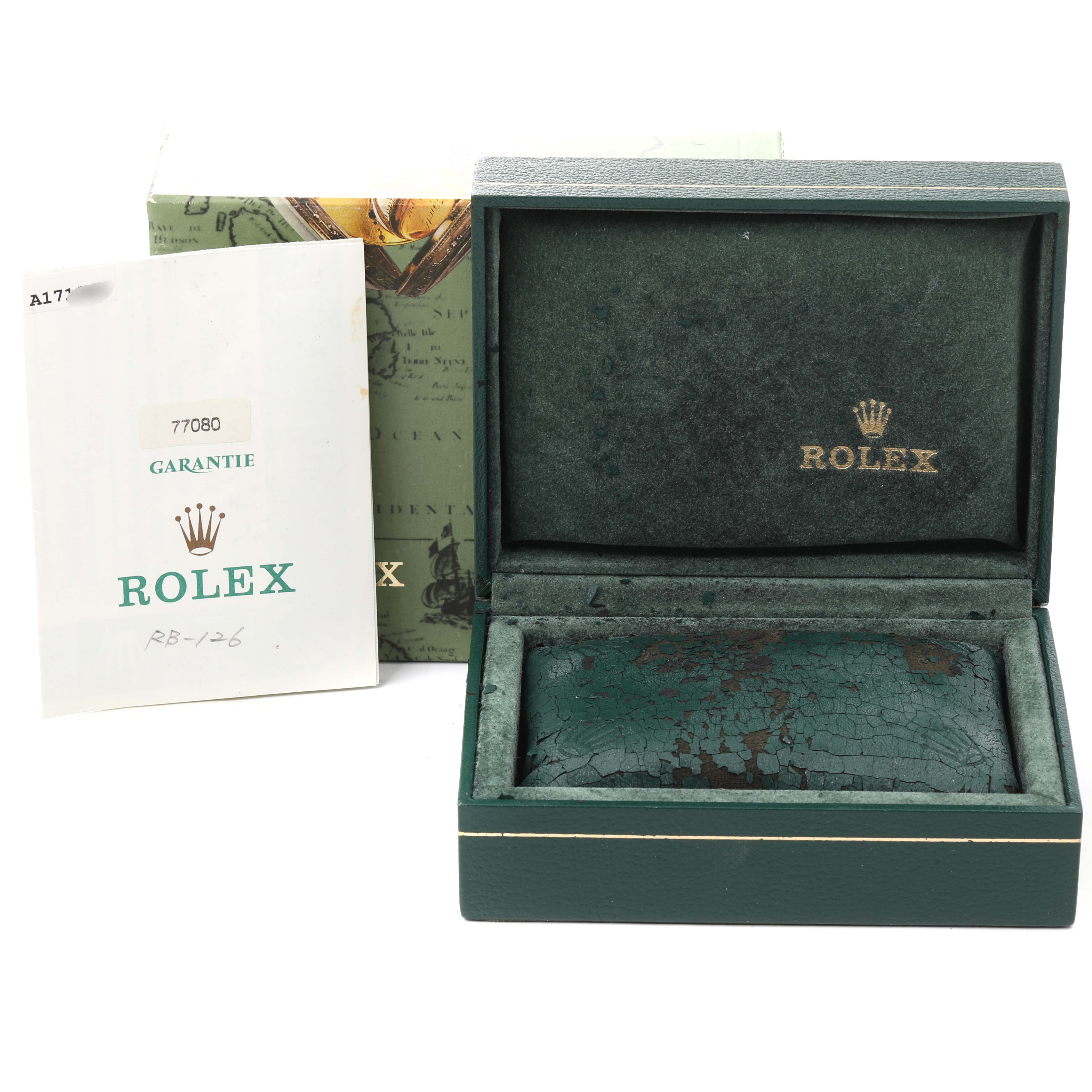 The image shows an empty Rolex Mid-Size 77080 Women
s Stainless Steel Black Dial 77080 Women
s Stainless Steel Black Dial watch box and its guarantee card, viewed from the front.
