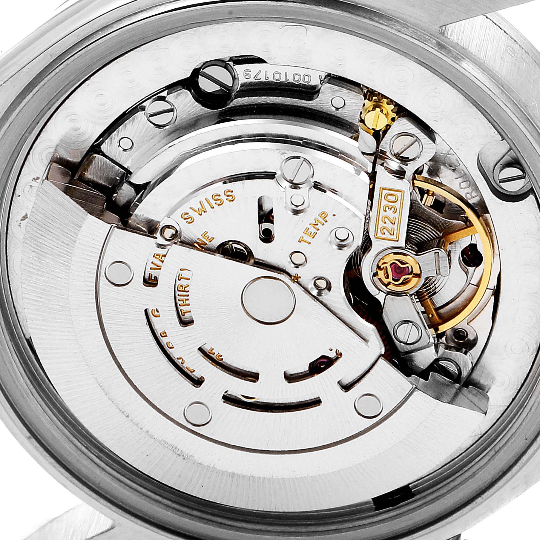The image shows a close-up of the movement and inner mechanism of a Rolex Mid-Size 77080 Women
s Stainless Steel Black Dial 77080 Women
s Stainless Steel Black Dial model watch.