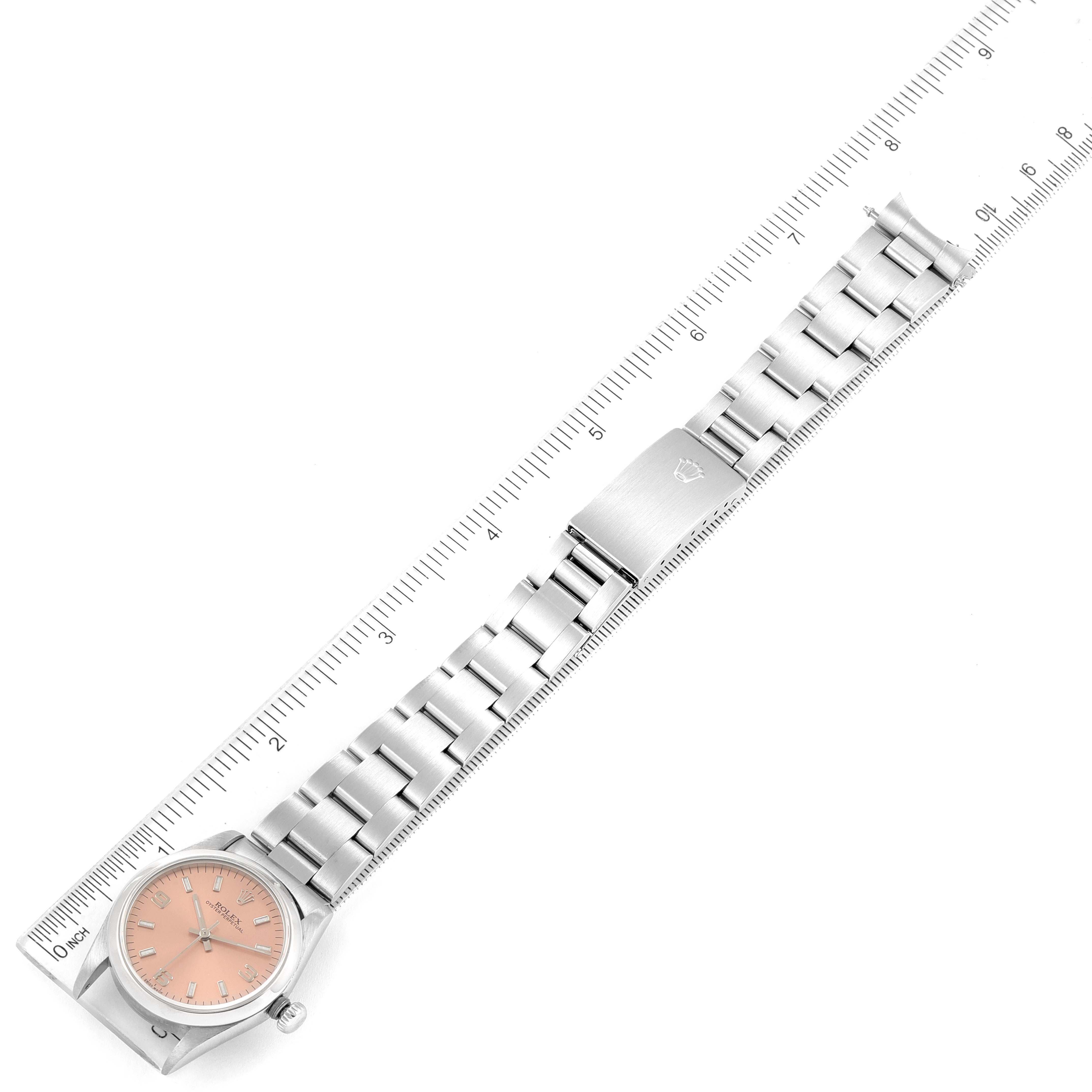 The image shows a top-down view of a Mid-Size Rolex watch, displaying the face, bracelet, and clasp alongside a ruler for scale.