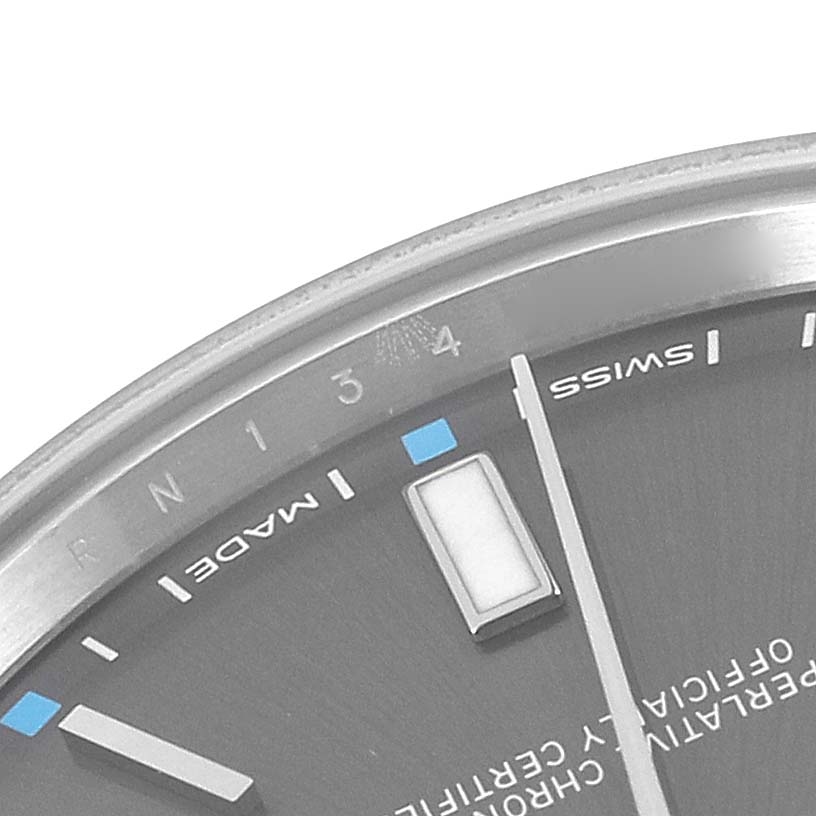 This image shows a close-up of the dial and part of the bezel of a Rolex Oyster Perpetual 114300 Men
s Stainless Steel Grey Dial 114300 Men
s Stainless Steel Grey Dial watch.