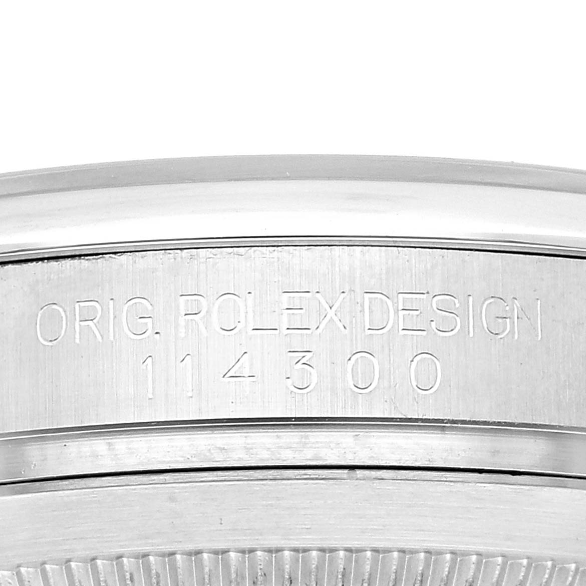 This image shows a close-up of the side engraving on a Rolex Oyster Perpetual 114300 Men
s Stainless Steel Grey Dial 114300 Men
s Stainless Steel Grey Dial model 114300.
