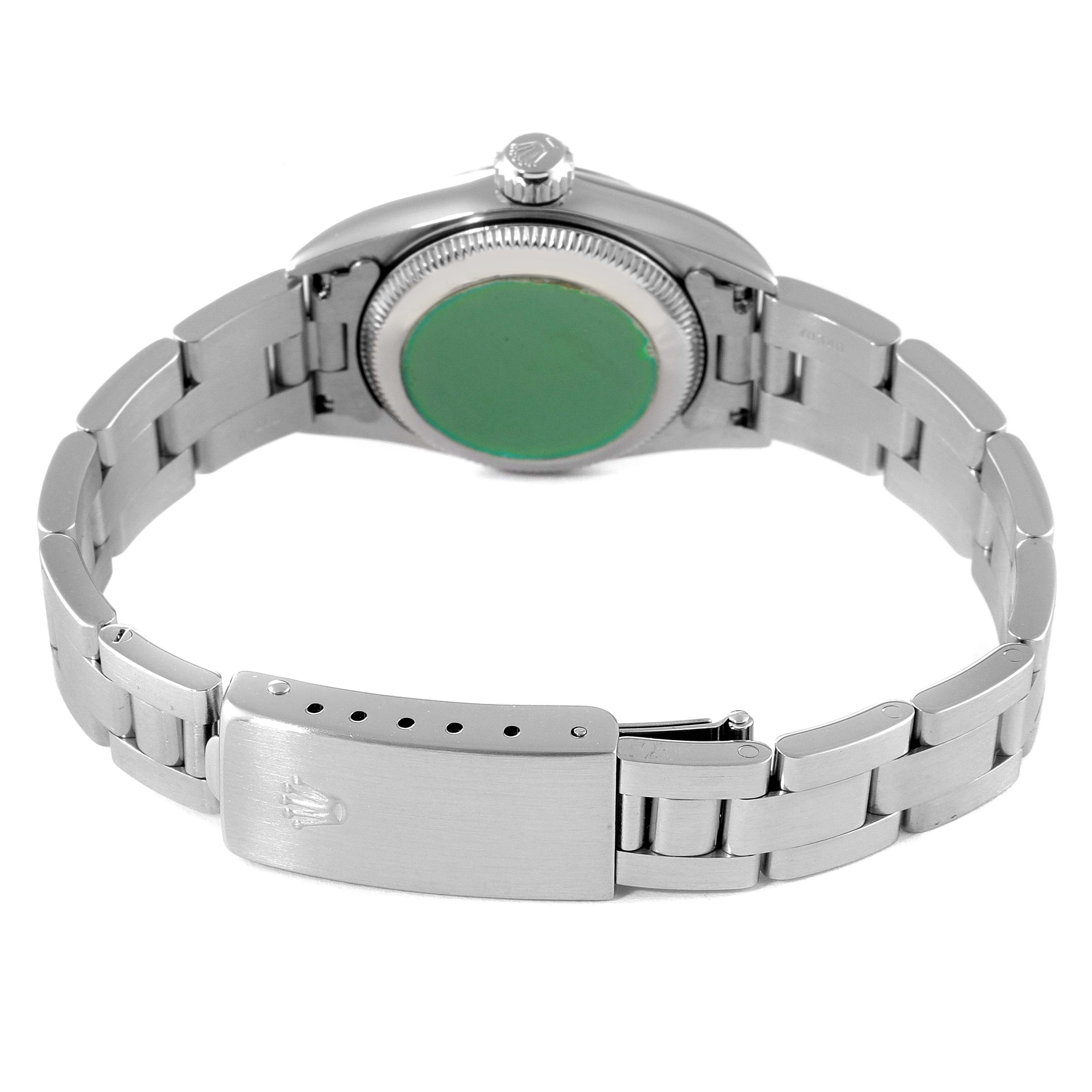 The image shows the back of a Rolex Oyster Perpetual 67230 Women's Stainless Steel Black Dial 67230 Women's Stainless Steel Black Dial watch, focusing on the case back, bracelet, and clasp.