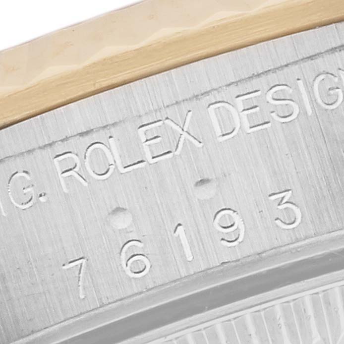 This close-up image shows the engraved case back of a Rolex Oyster Perpetual 76193 Women's Steel and Gold (two tone) Black Dial 76193 Women's Steel and Gold (two tone) Black Dial watch.