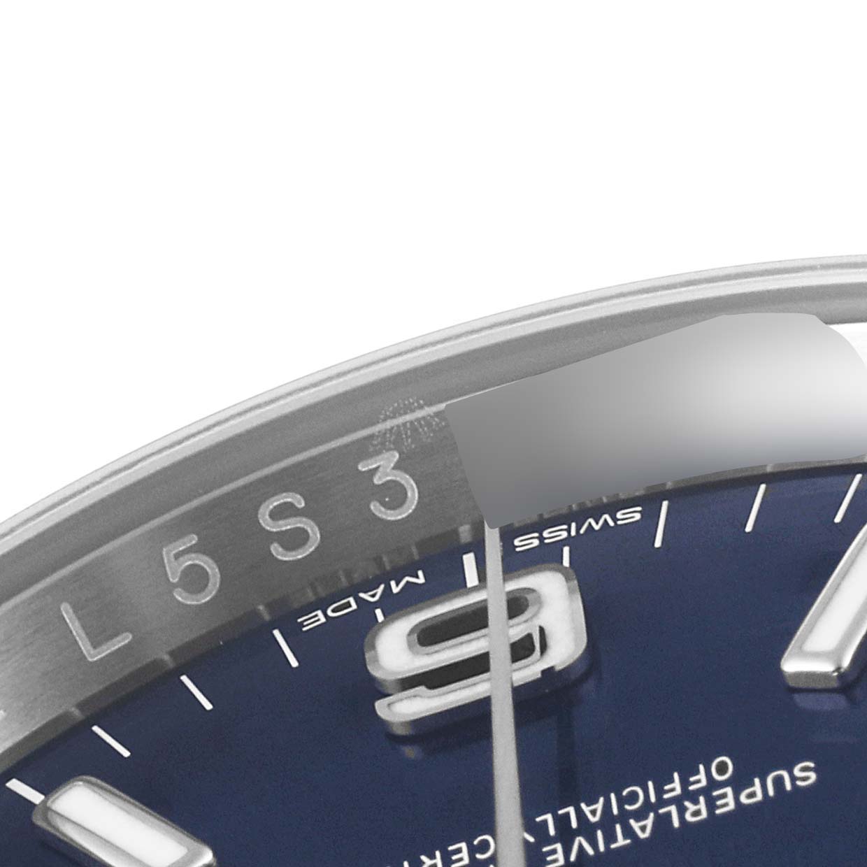 This close-up angle of a Rolex Oyster Perpetual 116000 Men's Stainless Steel Blue Dial 116000 Men's Stainless Steel Blue Dial watch shows part of the dial, including the numbers 9 and 7, and the edge of the case.