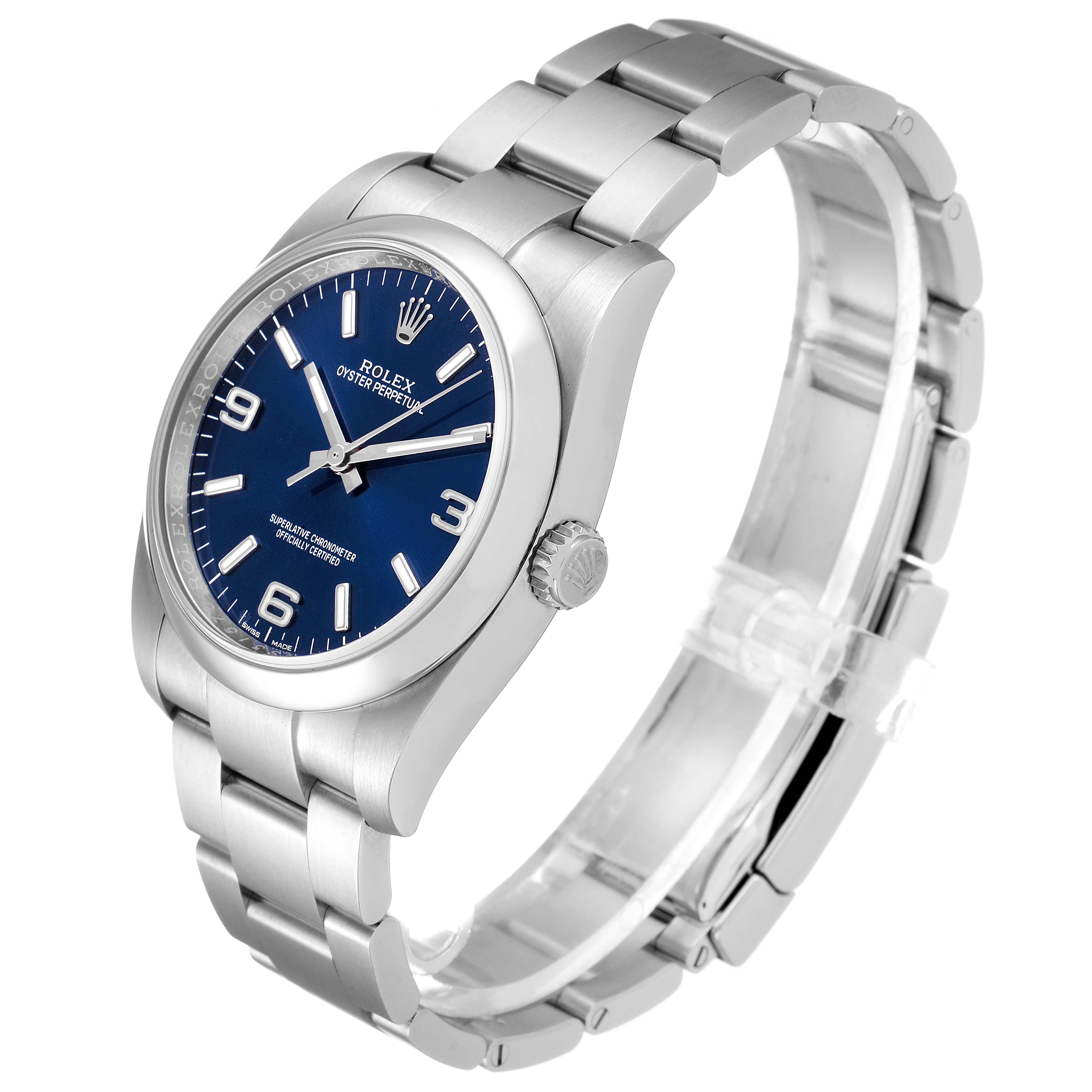 The image showcases a Rolex Oyster Perpetual 116000 Men's Stainless Steel Blue Dial 116000 Men's Stainless Steel Blue Dial watch at an oblique angle, highlighting its blue dial, stainless steel case, and bracelet.