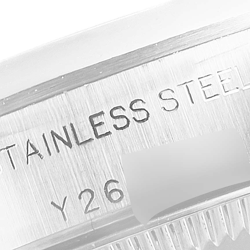 This image shows a close-up of the engraved stainless steel case back of a Rolex Oyster Perpetual 76080 Women's Stainless Steel Silver Dial 76080 Women's Stainless Steel Silver Dial watch.