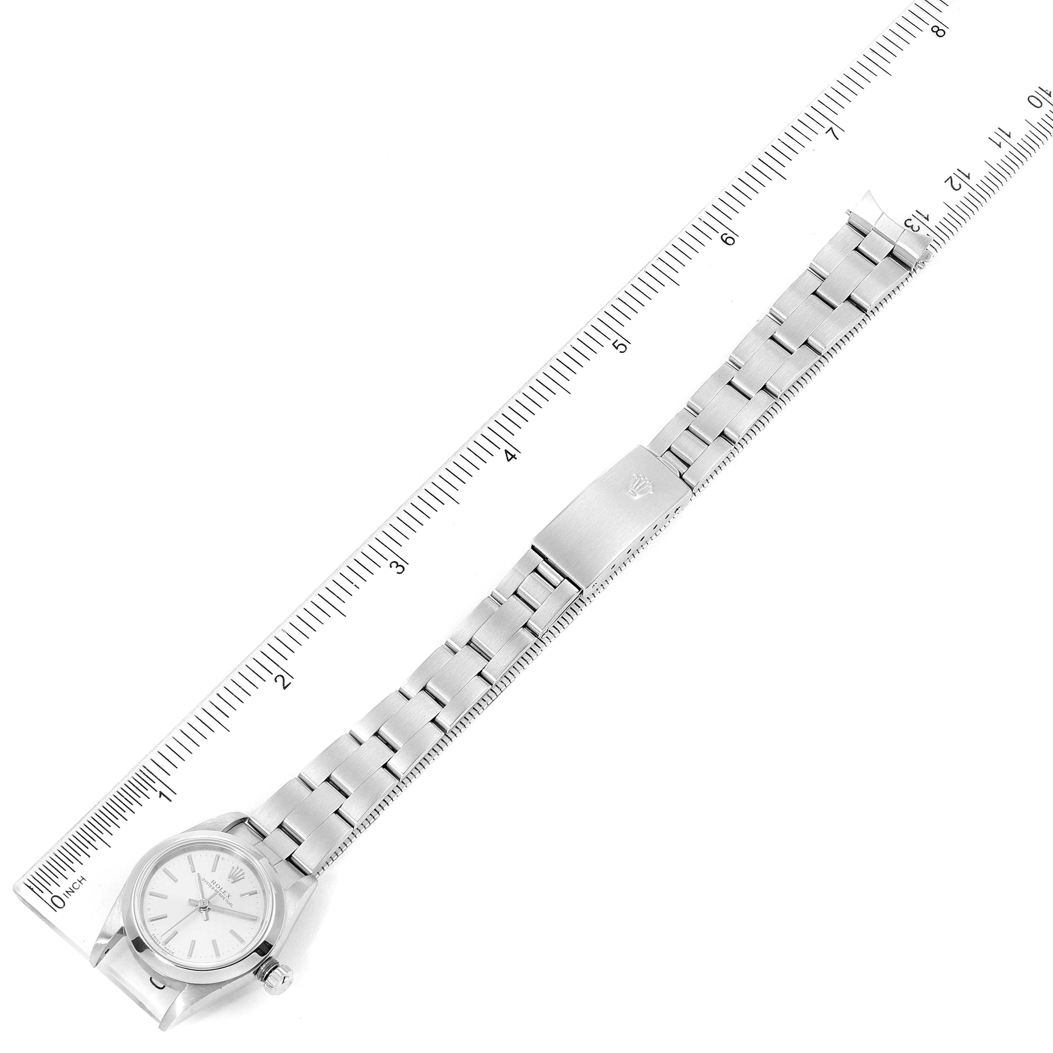The image shows a Rolex Oyster Perpetual 76080 Women's Stainless Steel Silver Dial 76080 Women's Stainless Steel Silver Dial watch laid flat next to a ruler, displaying the watch face and bracelet.