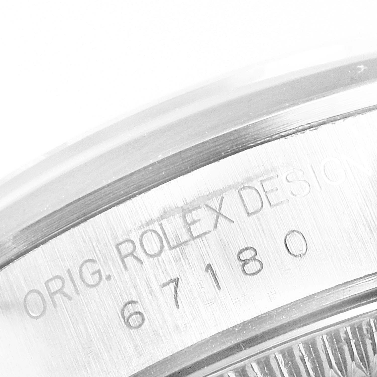 This image shows a close-up of the case back engraving of a Rolex Oyster Perpetual 67180 Women
s Stainless Steel Black Dial 67180 Women
s Stainless Steel Black Dial watch.