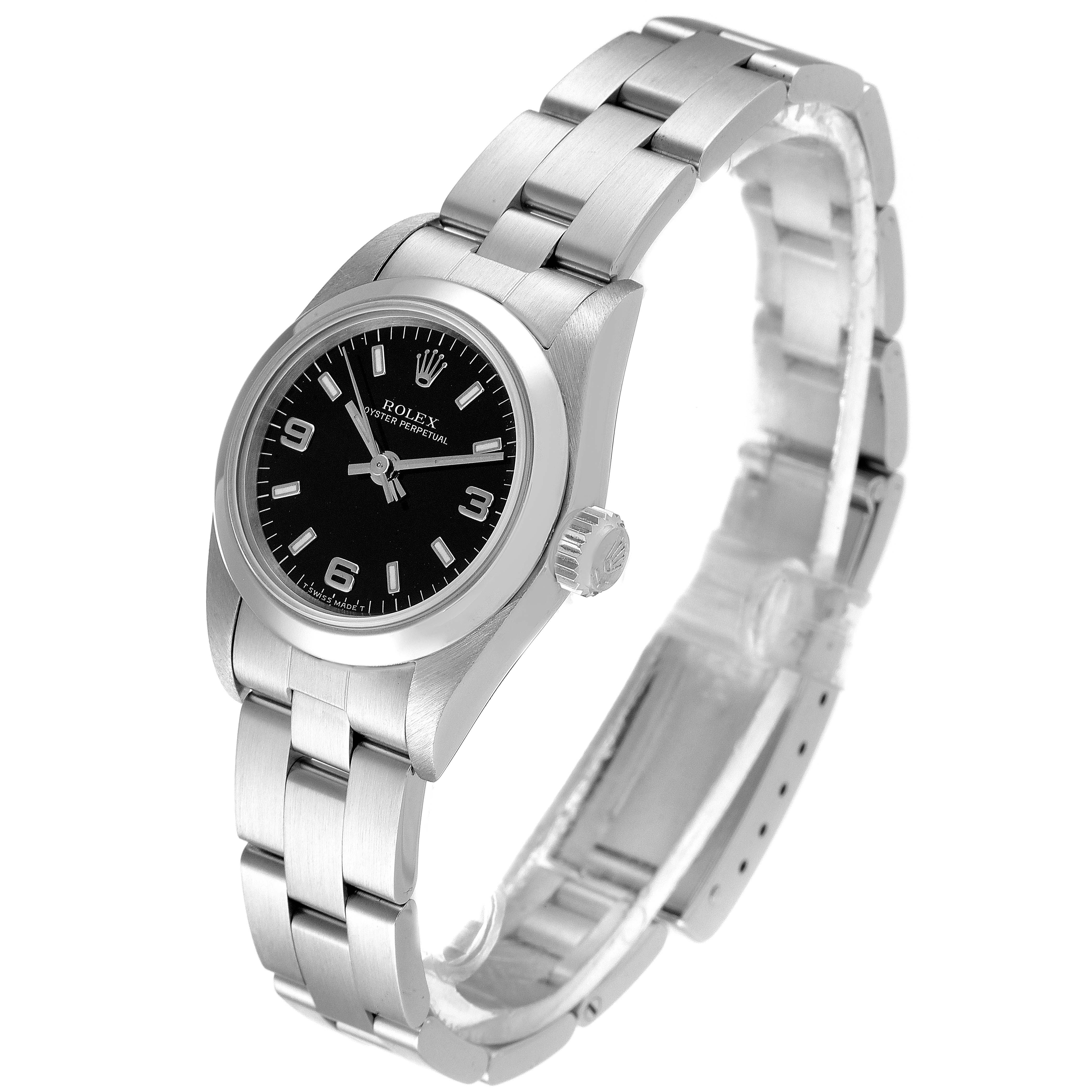 The image shows a Rolex Oyster Perpetual 67180 Women
s Stainless Steel Black Dial 67180 Women
s Stainless Steel Black Dial watch from a three-quarter angle, highlighting the face, bezel, crown, and bracelet.