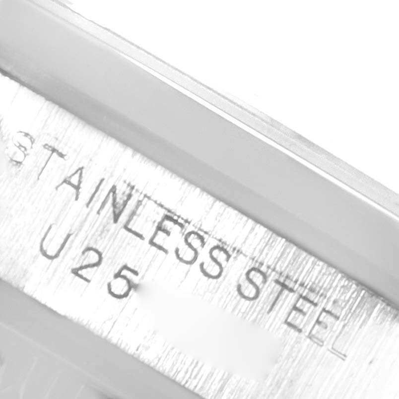 The image shows a close-up of the case side of the Rolex Oyster Perpetual 67180 Women
s Stainless Steel Black Dial 67180 Women
s Stainless Steel Black Dial watch, highlighting the engraved "STAINLESS STEEL" text.