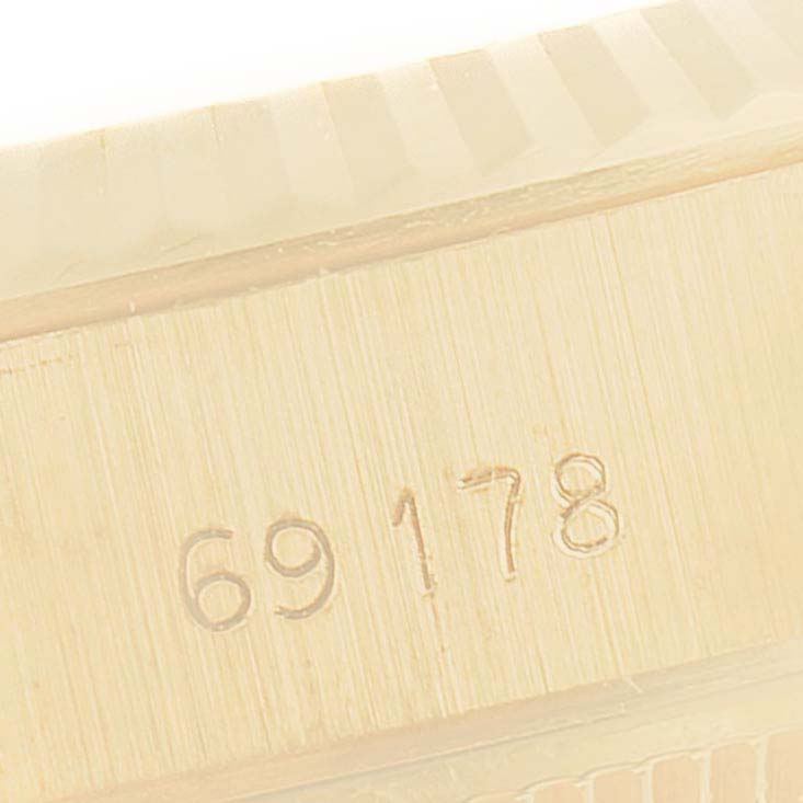 This close-up image shows the side view of the bezel and serial number engraving on a Rolex President 69178 Women's Yellow Gold Champagne Dial 69178 Women's Yellow Gold Champagne Dial model watch.