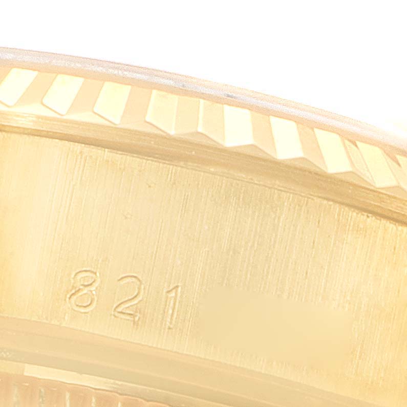 The image shows a close-up shot of the serial number engraving and fluted bezel of a Rolex President 69178 Women
s Yellow Gold Champagne Dial 69178 Women
s Yellow Gold Champagne Dial model watch.
