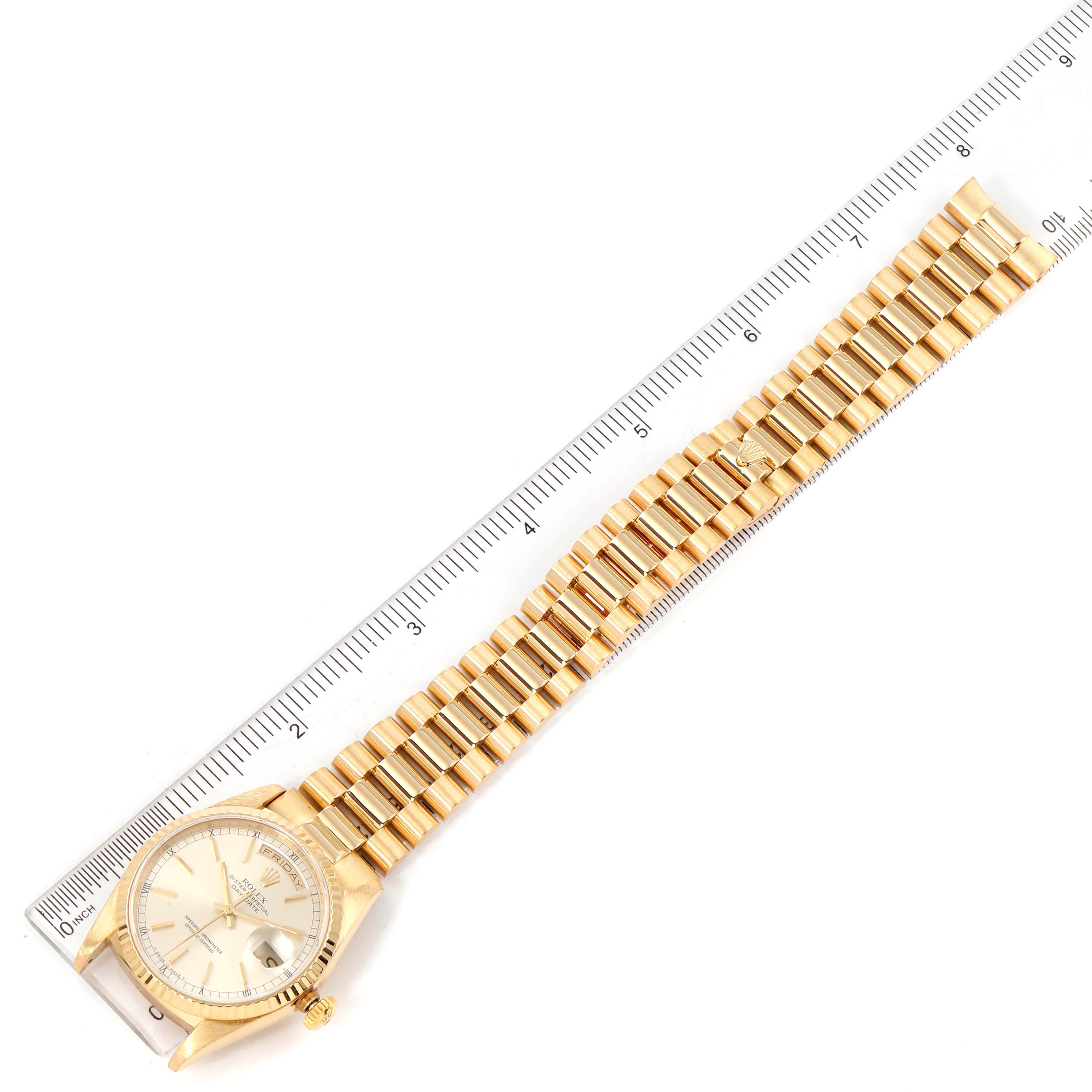 The image shows a top view of a Rolex President 18238 Men's Yellow Gold Silver Dial 18238 Men's Yellow Gold Silver Dial model watch laid alongside a ruler for measuring.