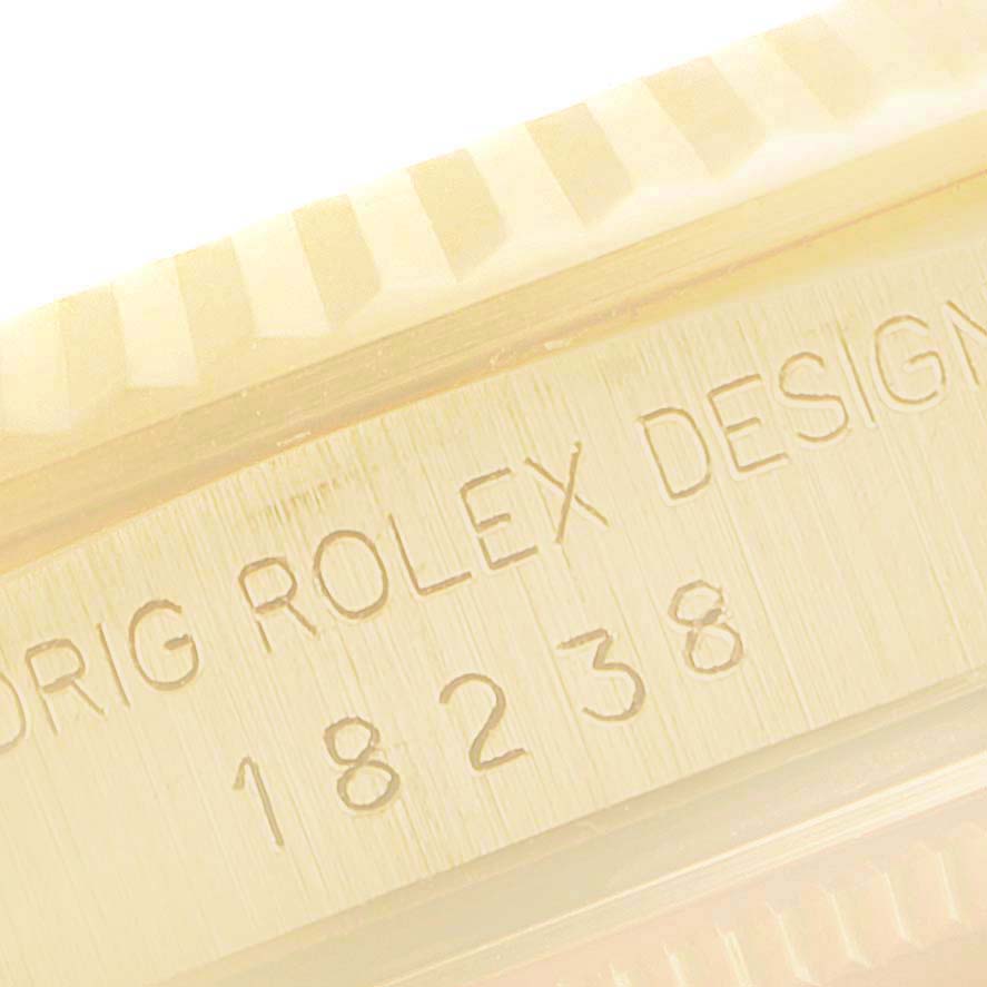This close-up image of the Rolex President 18238 Men's Yellow Gold Silver Dial 18238 Men's Yellow Gold Silver Dial model shows the engraved watch case with the model number and brand name.
