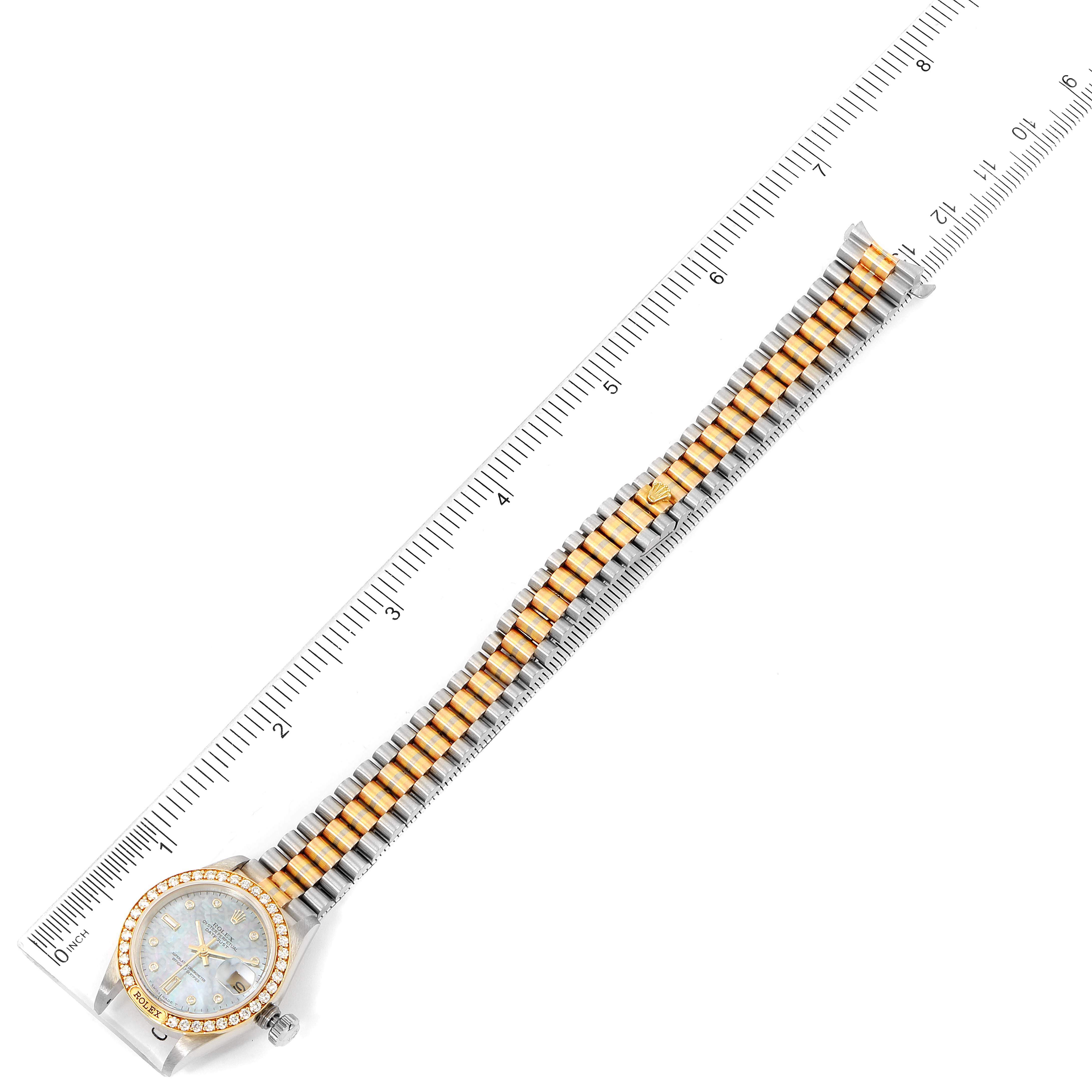 The image shows an overhead view of a Rolex President 69149 Women's White Gold Mother of Pearl Dial 69149 Women's White Gold Mother of Pearl Dial model watch with a two-tone bracelet, positioned alongside a ruler for scale.
