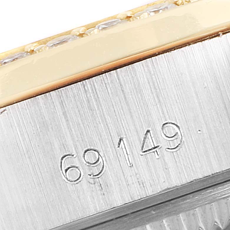 The image shows a close-up of the serial number and part of the bezel of a Rolex President 69149 Women's White Gold Mother of Pearl Dial 69149 Women's White Gold Mother of Pearl Dial model watch.