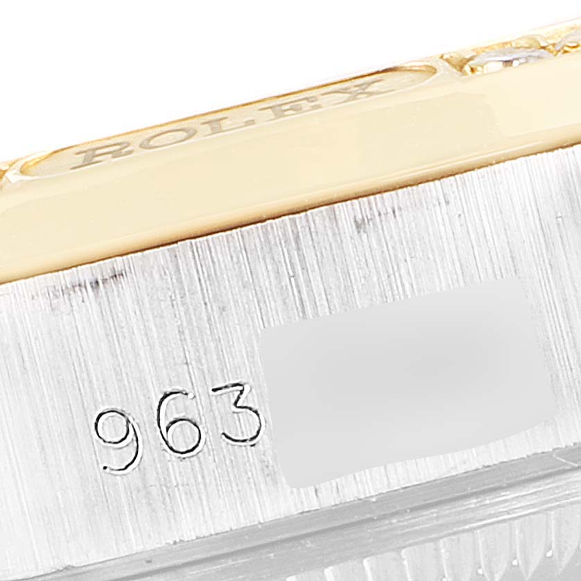 The image shows a close-up angle of the side of a Rolex President 69149 Women's White Gold Mother of Pearl Dial 69149 Women's White Gold Mother of Pearl Dial model watch, highlighting the serial number and part of the logo.