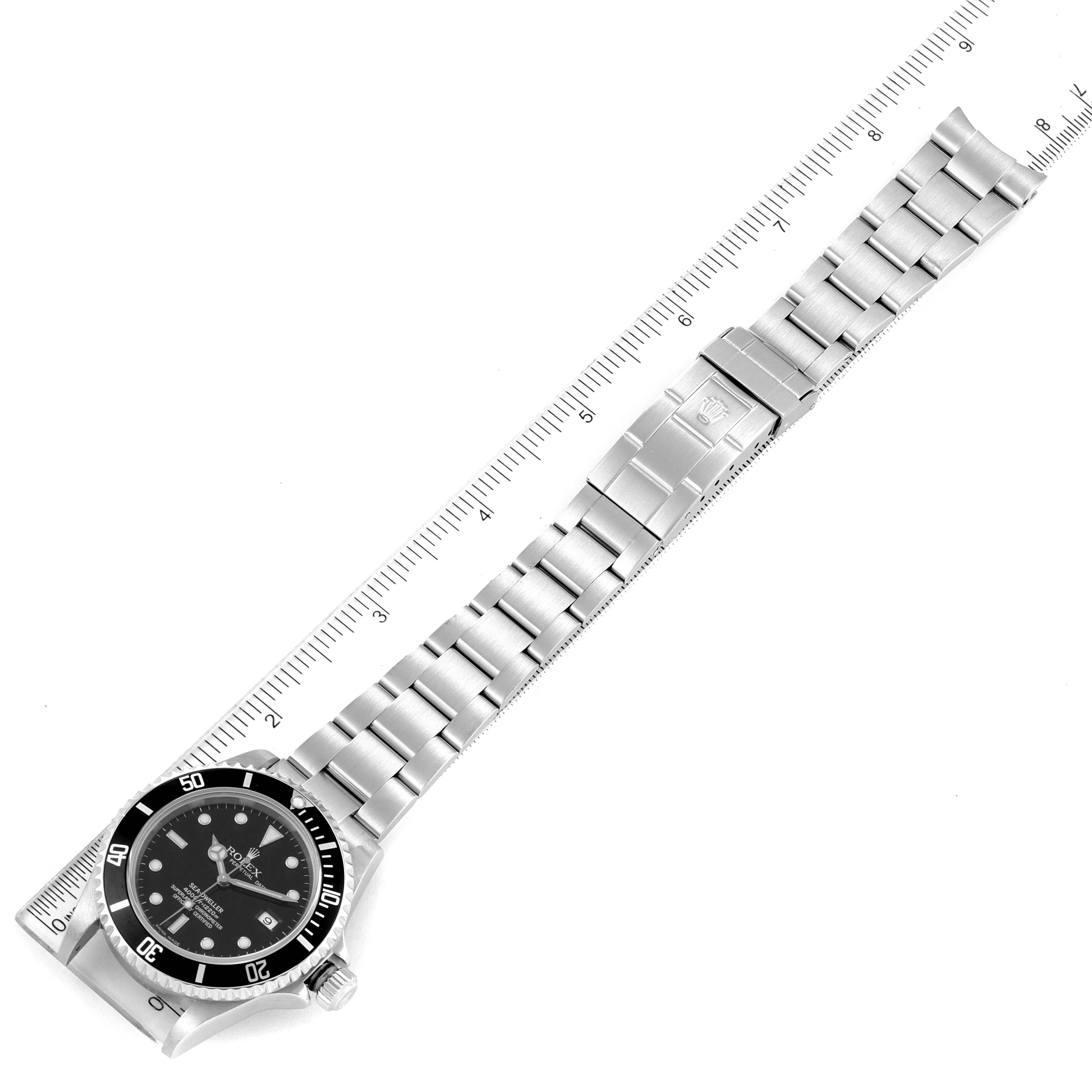 Image shows a top-down view of the Rolex Sea-Dweller 16600 Men
s Stainless Steel Black Dial 16600 Men
s Stainless Steel Black Dial watch, displaying its full bracelet and bezel, placed beside a ruler.