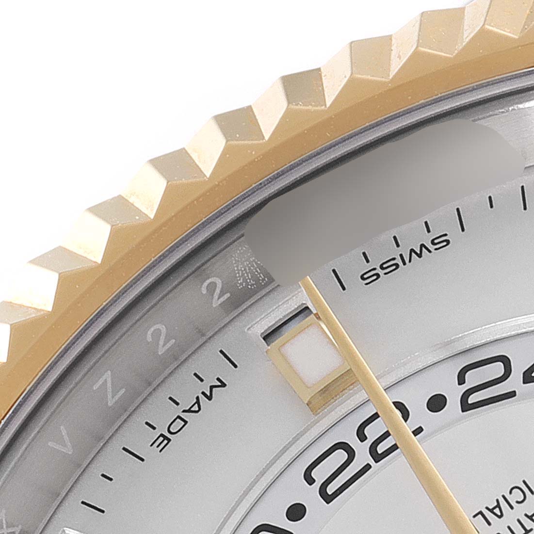 The image shows a close-up of the Rolex Sky-Dweller 326933 Men's Steel and Gold (two tone) White Dial 326933 Men's Steel and Gold (two tone) White Dial's bezel, part of the dial, and hour markers.