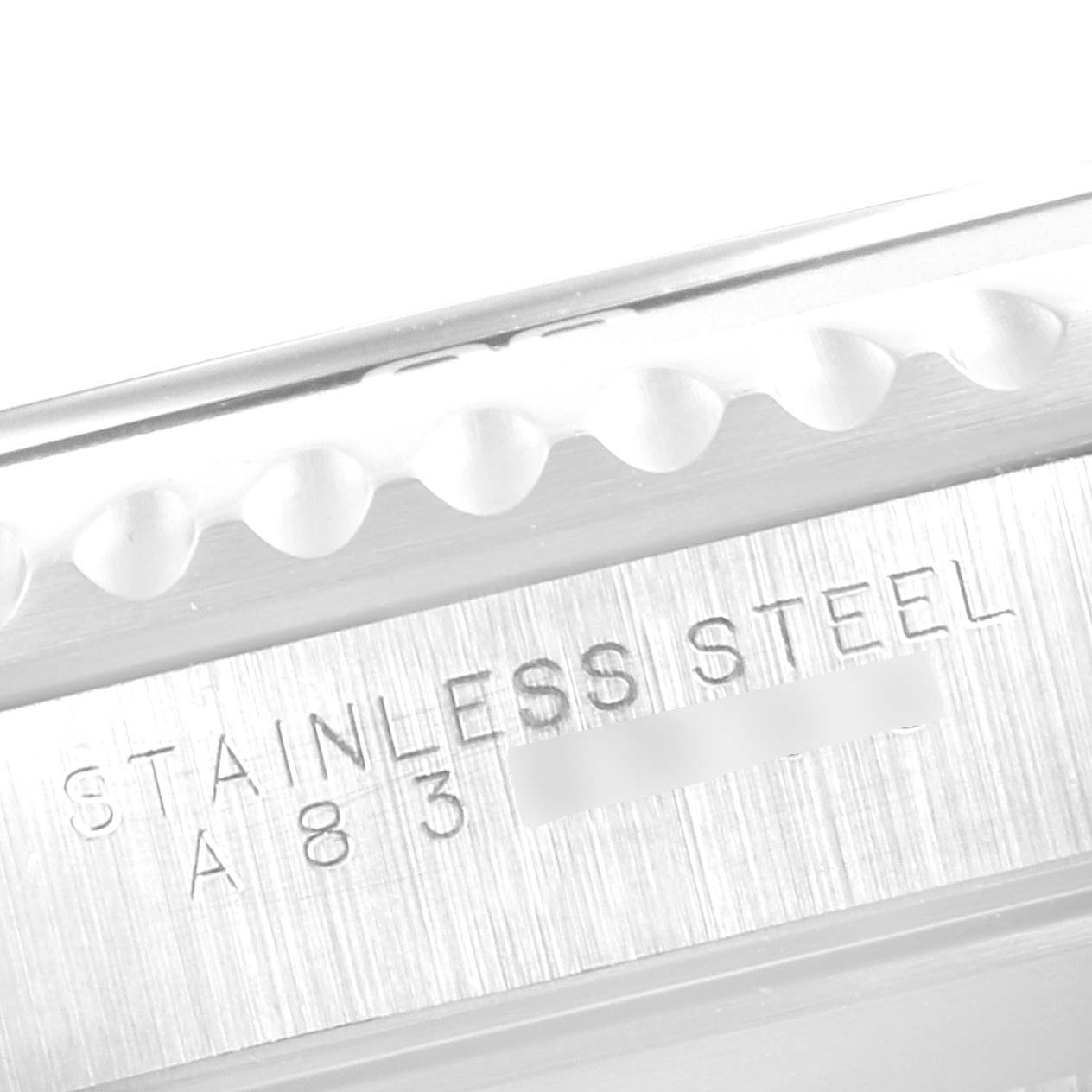 This close-up image shows the stainless steel engraving and part of the bezel of a Rolex Submariner 14060 Men's Stainless Steel Black Dial 14060 Men's Stainless Steel Black Dial watch.