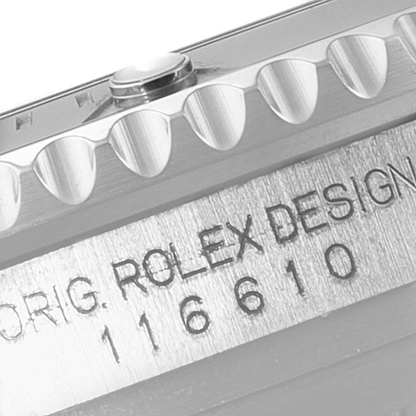The image shows a close-up of the side view of a Rolex Submariner 116610 Men
s Stainless Steel Black Dial 116610 Men
s Stainless Steel Black Dial bezel and part of the case with the engraving visible.