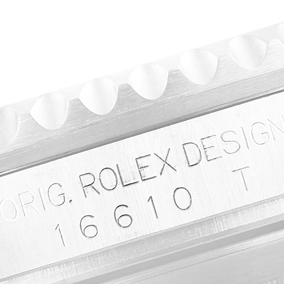 This image shows an angled close-up of the Rolex Submariner 16610LV Men
s Stainless Steel Black Dial 16610LV Men
s Stainless Steel Black Dial model 16610
s case with the engraved serial and design numbers.