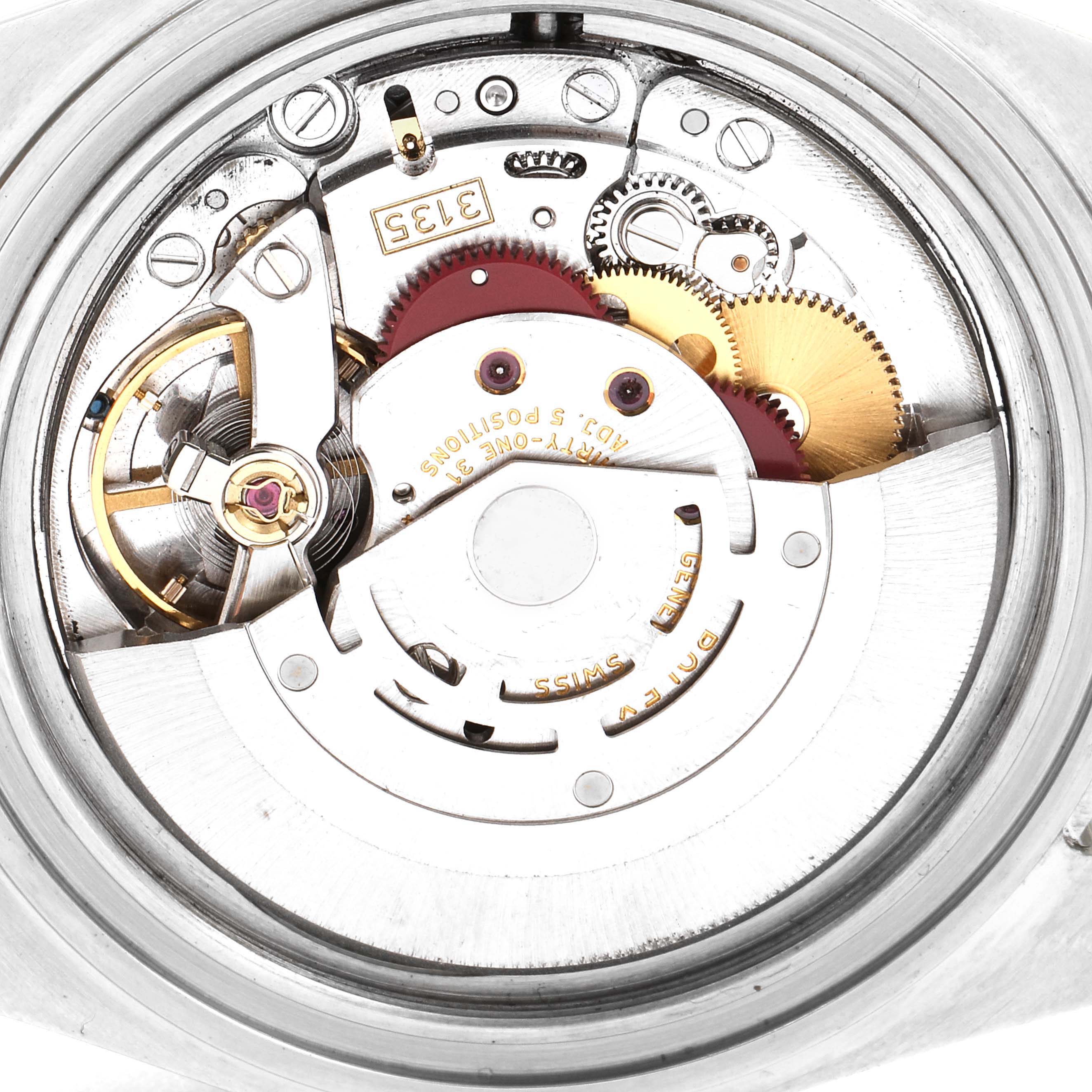 This image shows the internal mechanism of a Rolex Submariner 16610LV Men
s Stainless Steel Black Dial 16610LV Men
s Stainless Steel Black Dial watch from a top-down angle, highlighting the gears and rotor.