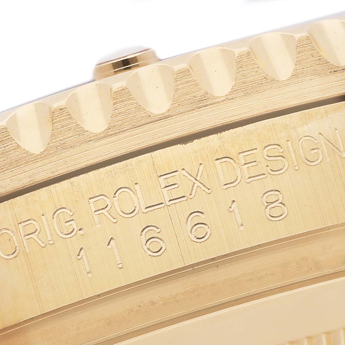 This image shows the side view of a Rolex Submariner 116618LB Men's Yellow Gold Blue Dial 116618LB Men's Yellow Gold Blue Dial's bezel and engraved case with the model number "116618."