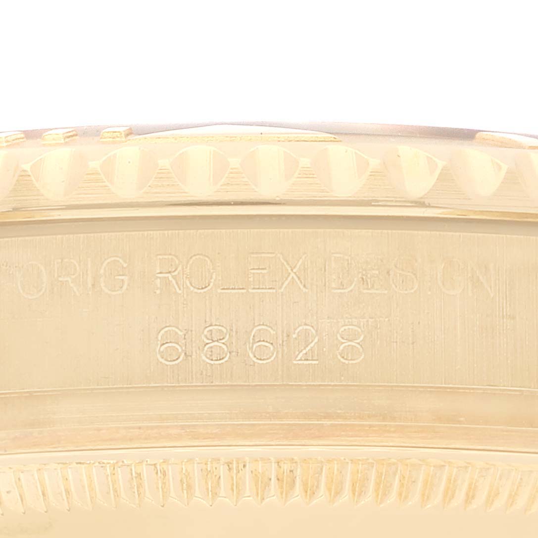 This image shows a close-up of the case side with the engraved design number for a Rolex Yacht-Master 68628 Men's Yellow Gold White Dial 68628 Men's Yellow Gold White Dial watch.