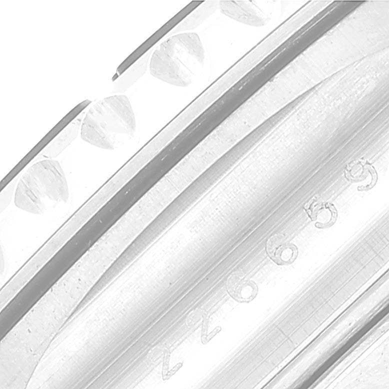 This close-up image of the Rolex Yacht-Master 226659 Men's White Gold Black Dial 226659 Men's White Gold Black Dial watch shows part of the bezel with its unique markings and part of the serial number.