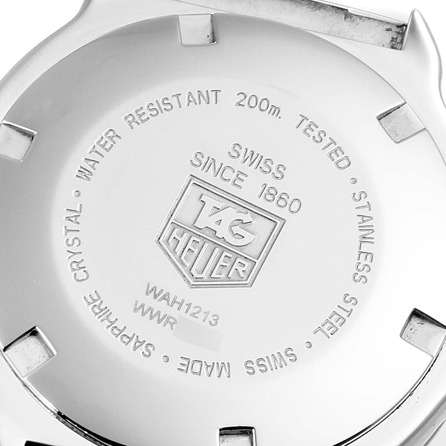 The image shows the back case of a Formula 1 model by Tag Heuer, displaying branding, specifications, and serial numbers.