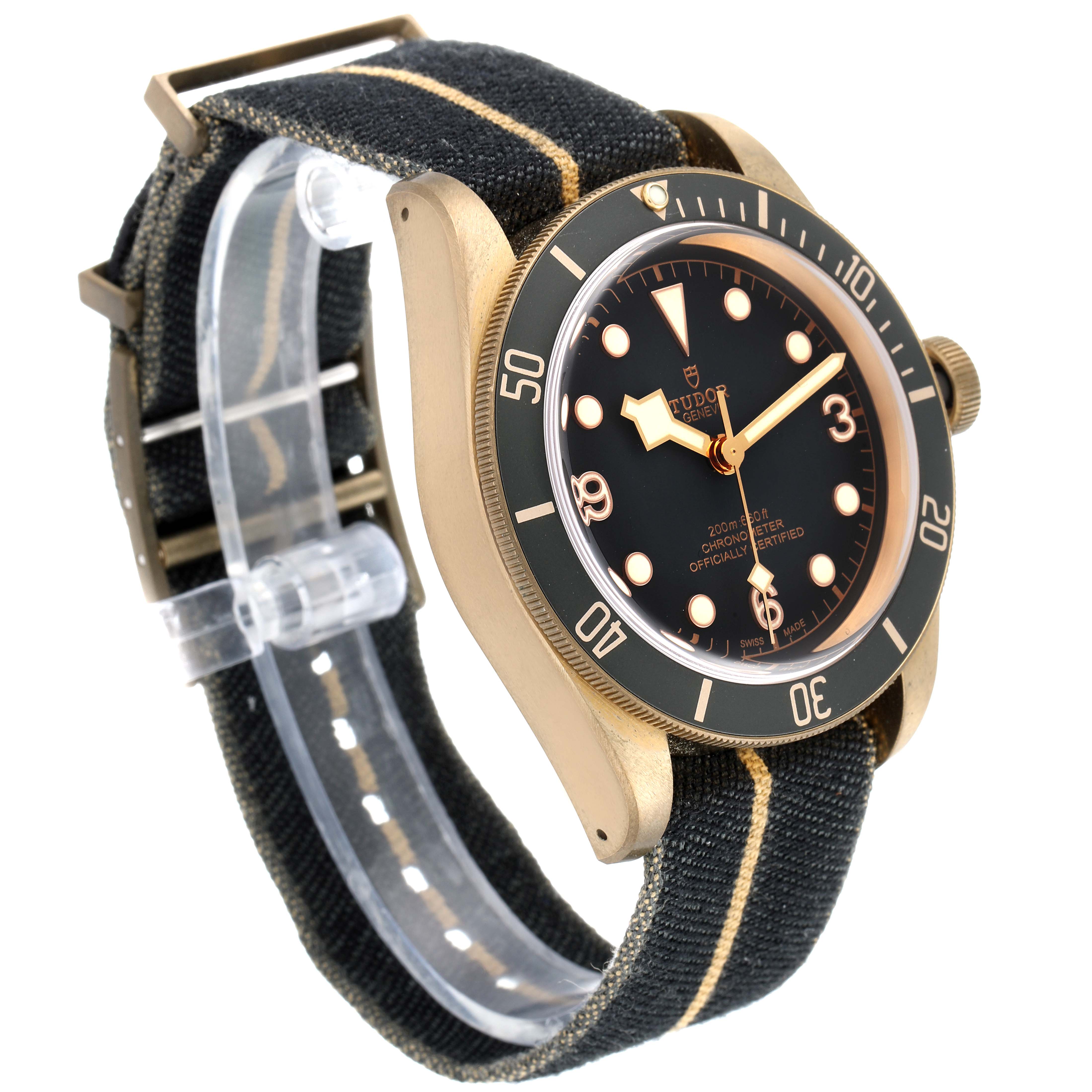 This side-angle view of the Tudor Heritage Black Bay 79250BA Men's Bronze Black Dial 79250BA Men's Bronze Black Dial watch features its face, bezel, case, and fabric strap.