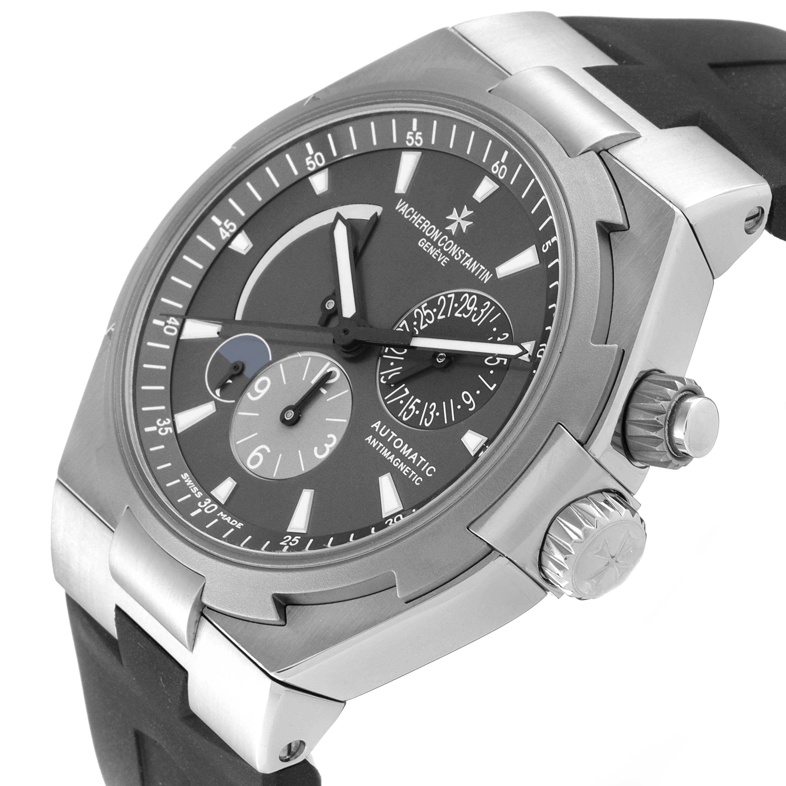 The image shows a Vacheron Constantin Overseas 47450/000W-9511 Men's Stainless Steel Grey Dial 47450/000W-9511 Men's Stainless Steel Grey Dial model watch at an angled close-up, highlighting its face, bezel, crown, and strap.