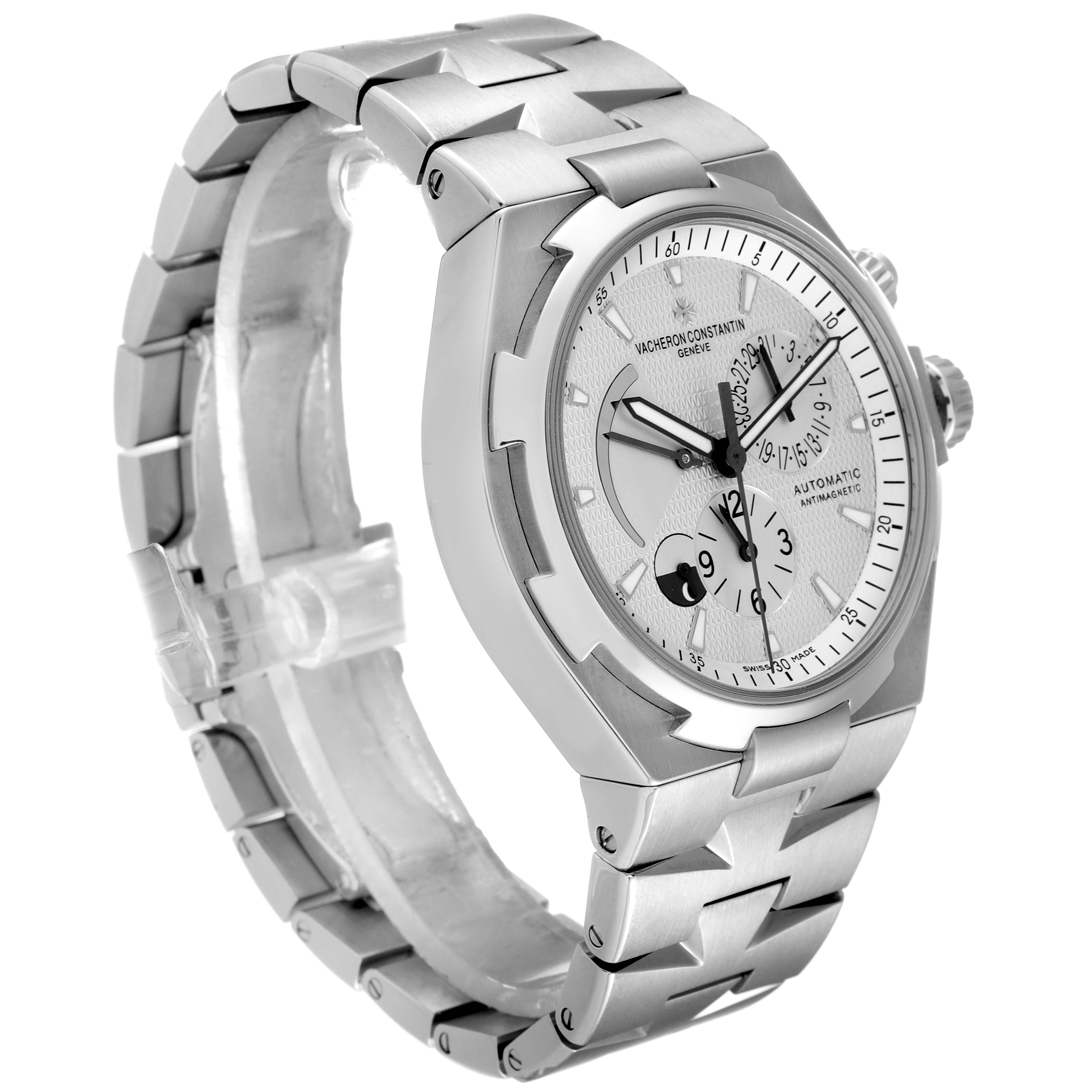 The image presents a Vacheron Constantin Overseas 47450/B01A-9226 Men's Stainless Steel Silver Dial 47450/B01A-9226 Men's Stainless Steel Silver Dial watch from an angled side view, showing the dial, bezel, and bracelet.