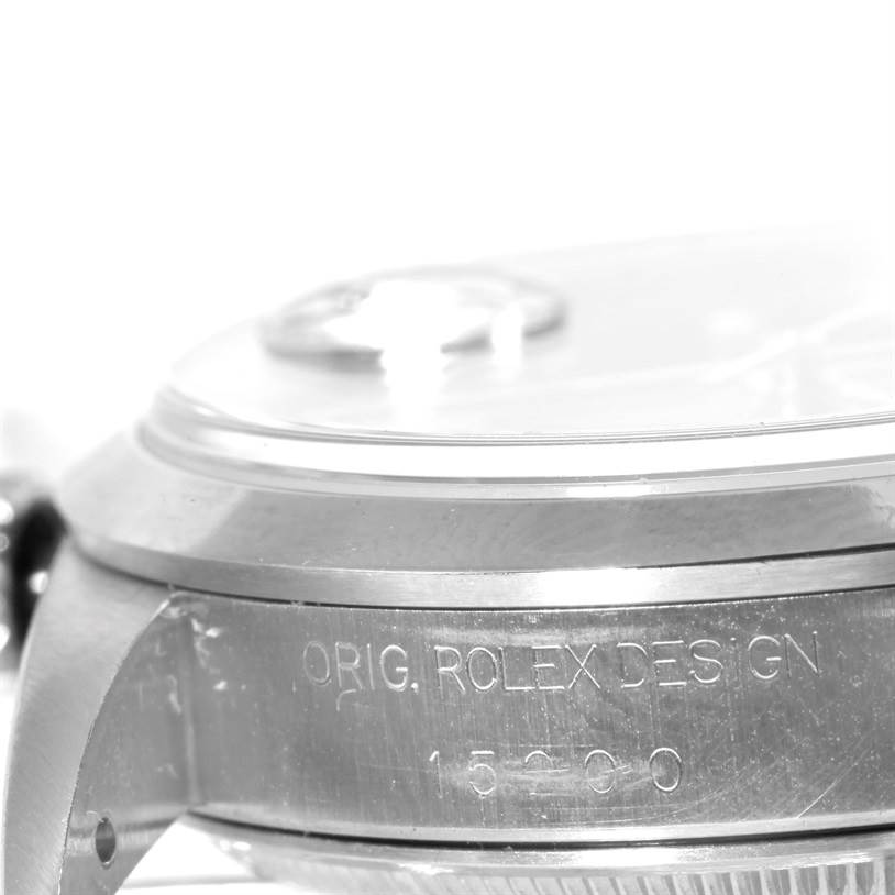 The image shows a close-up angle of the side of a Rolex Date 15200 Men's Stainless Steel Blue Dial 15200 Men's Stainless Steel Blue Dial model watch displaying the case and edge of the crystal.