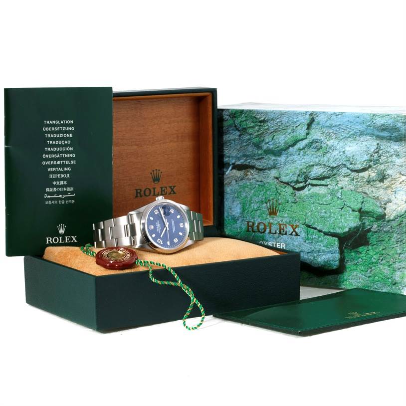 The Rolex Date 15200 Men's Stainless Steel Blue Dial 15200 Men's Stainless Steel Blue Dial model watch is displayed front-on with its box, booklet, and tag visible.