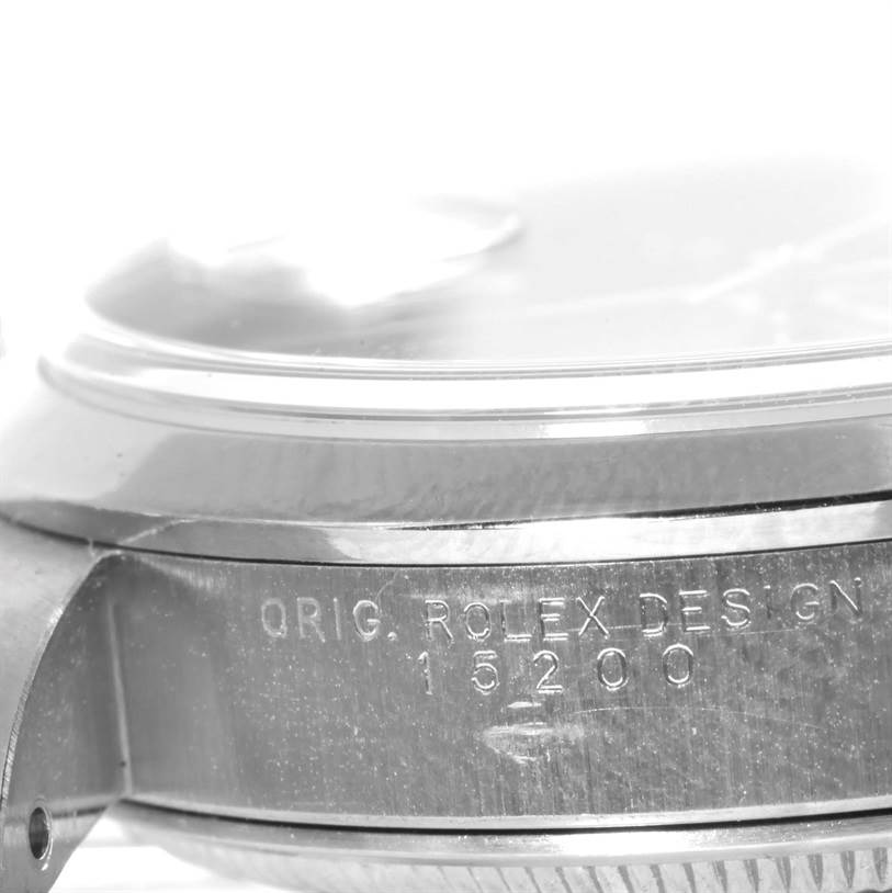 The image shows a close-up side angle of the Rolex Date 15200 Men's Stainless Steel Black Dial 15200 Men's Stainless Steel Black Dial model watch case, focusing on the engraved serial number and design text.