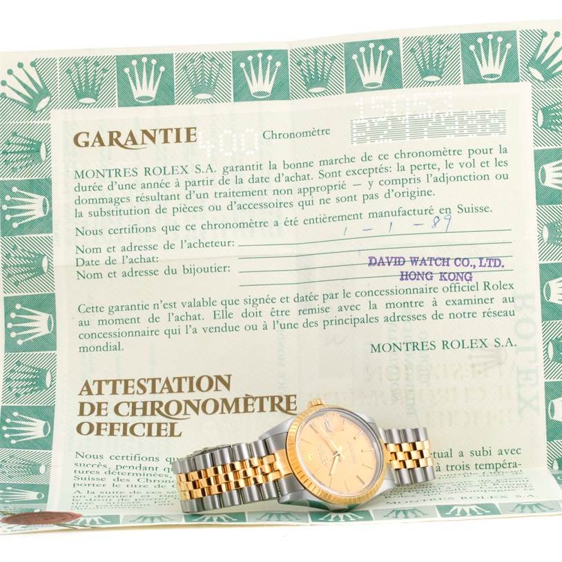 The image shows a Rolex Date 15053 Men's Steel and Gold (two tone) Champagne Dial 15053 Men's Steel and Gold (two tone) Champagne Dial model watch positioned at an angle, along with its warranty certificate.