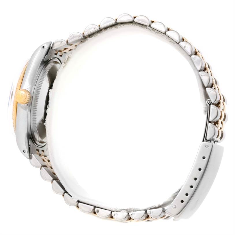 This image shows a side view of the Rolex Date 15053 Men's Steel and Gold (two tone) Champagne Dial 15053 Men's Steel and Gold (two tone) Champagne Dial model watch focusing on the crown, case, and bracelet.