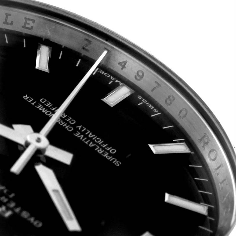 This image shows a close-up angle of the dial, hands, and inner bezel of the Date model by Rolex.
