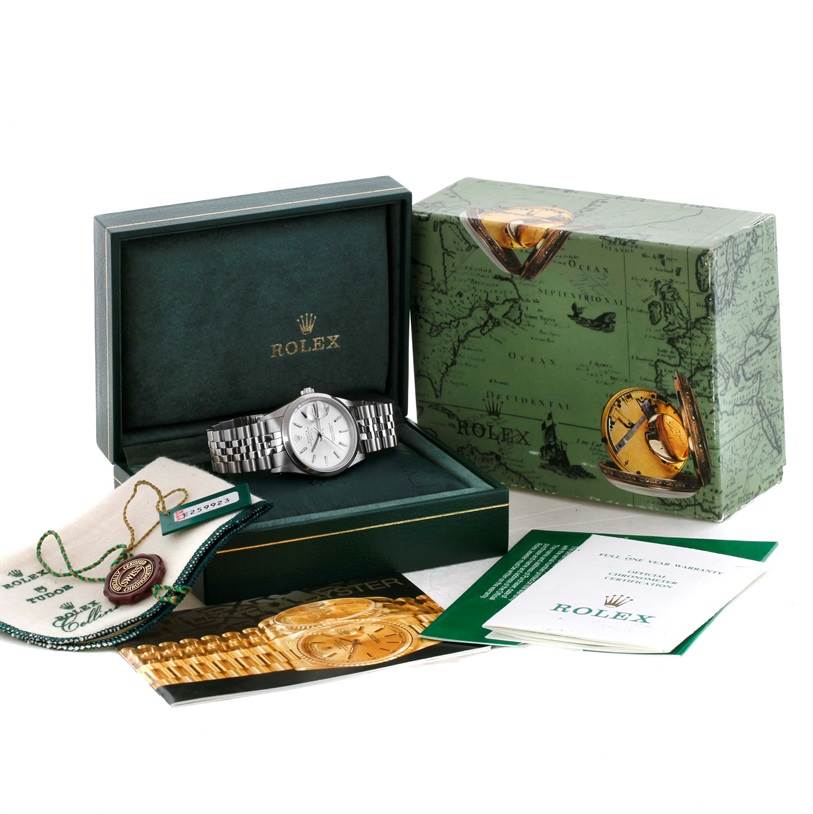This image shows a Rolex Date 15200 Men's Stainless Steel Silver Dial 15200 Men's Stainless Steel Silver Dial model watch in its open box, accompanied by tags, booklets, and a decorative outer box.