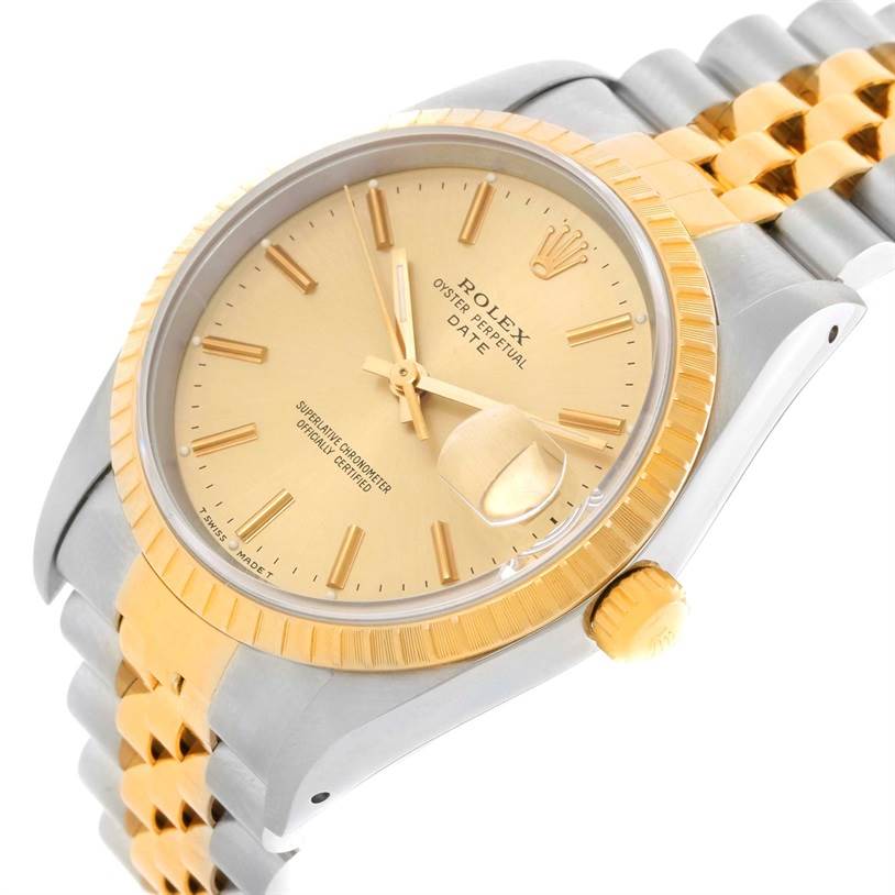 The image shows a close-up angled view of a Rolex Date 15223 Men's Steel and Gold (two tone) Champagne Dial 15223 Men's Steel and Gold (two tone) Champagne Dial model watch, highlighting its gold dial, bezel, and two-tone bracelet.