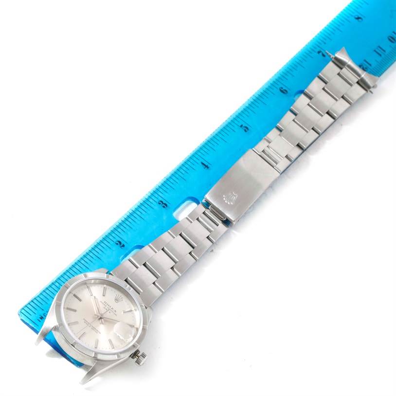 The image shows a Rolex Date 15210 Men's Stainless Steel Silver Dial 15210 Men's Stainless Steel Silver Dial model watch laid flat with a blue ruler for size reference.