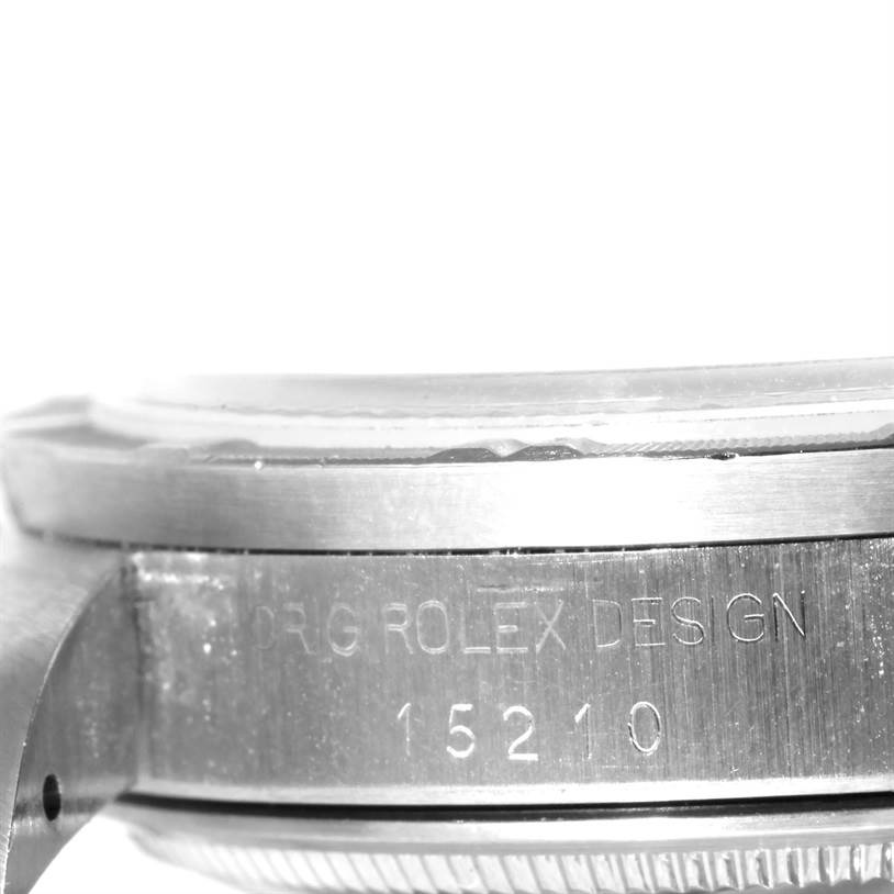 The image shows a close-up side view of the case of a Rolex Date 15210 Men's Stainless Steel Silver Dial 15210 Men's Stainless Steel Silver Dial model, including the engraved design number.
