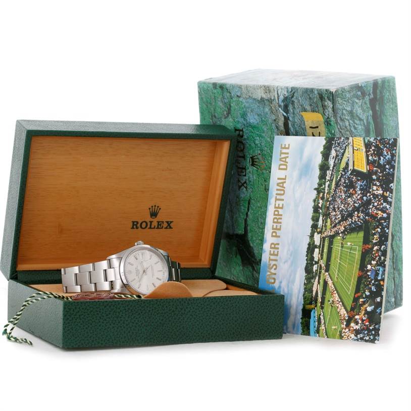 The Rolex Date 15200 Men's Stainless Steel Silver Dial 15200 Men's Stainless Steel Silver Dial watch is shown at an angle, inside its box with the booklet and tag displayed beside it.