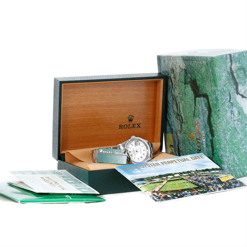 The image shows a Rolex Date 15210 Men's Stainless Steel White Dial 15210 Men's Stainless Steel White Dial watch laying inside its open box, accompanied by manuals and packaging.